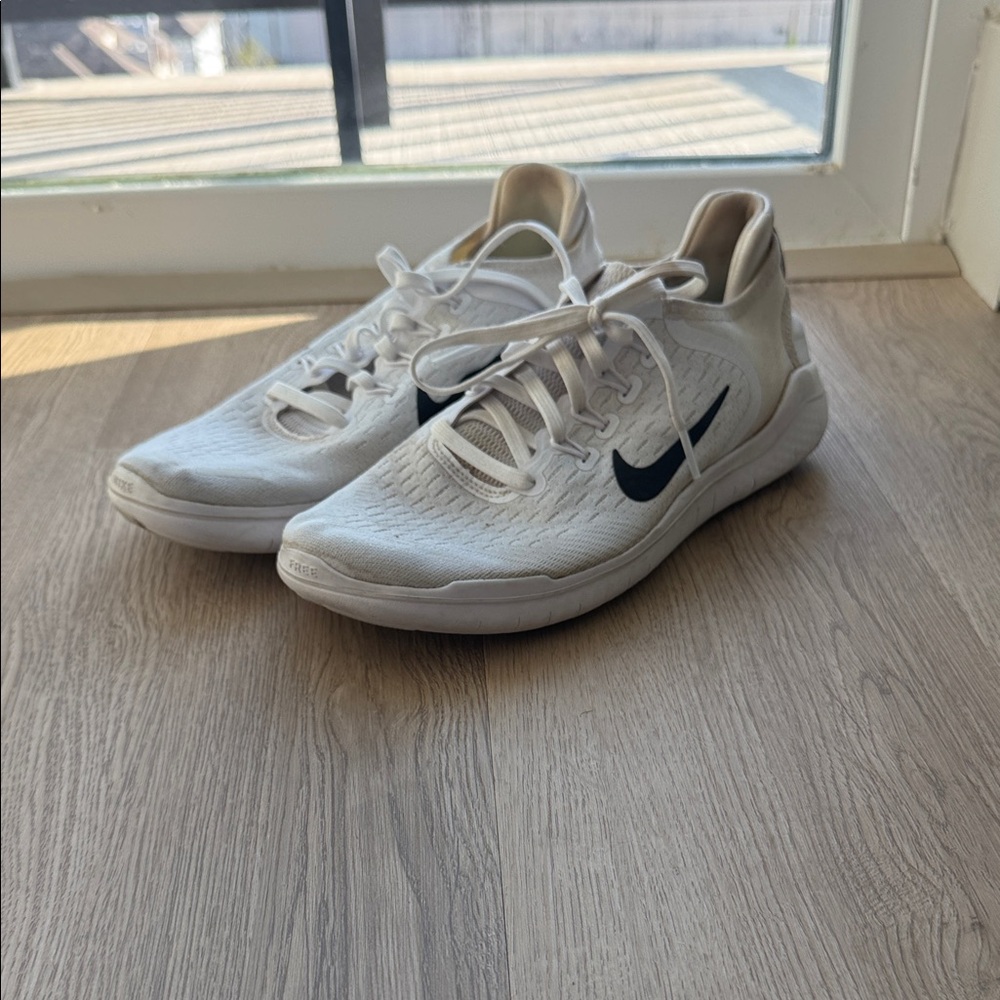 Nike White Athletic Shoes with Black Swoosh